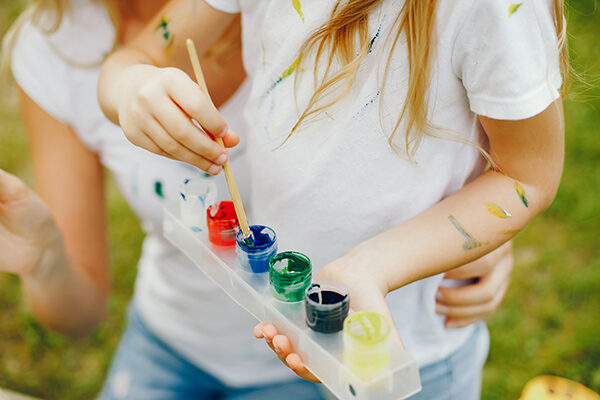 Mother with daughter drawing in a park